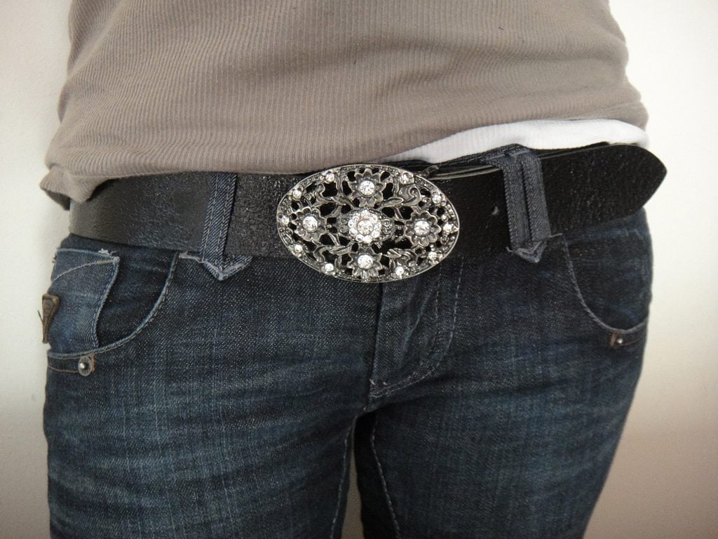 Silver belt buckle around waist