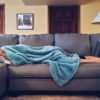 Laying on sofa with blanket