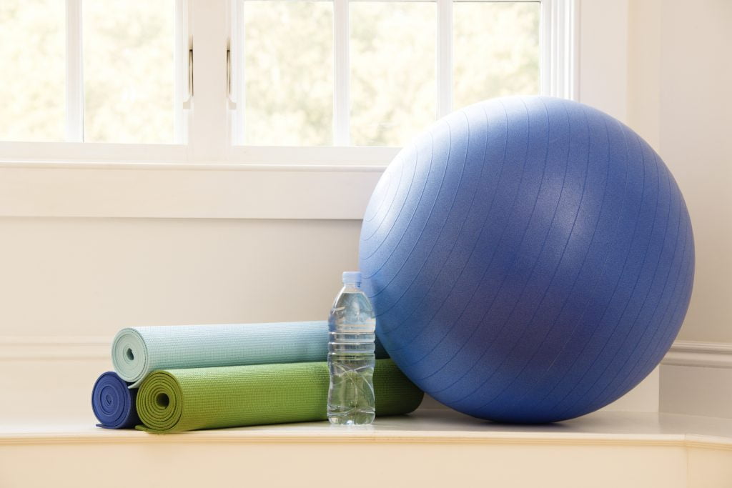 Exercise ball and yoga mat ready for waist training